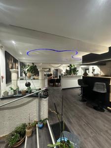 a living room with a piano and a blue cord on the ceiling at Auberge aux 1000 saveurs in Malay-le-Petit