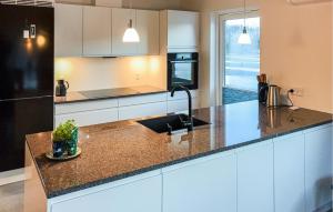 a kitchen with a sink and a counter top at Awesome Home In Ringkøbing With Wifi in Ringkøbing