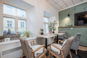 a room with a table and chairs and a window at Old Town Boho Guesthouse in Tallinn