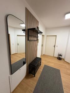 a mirror on the wall of a room with a bench at Großzügiges Design-Loft in Aulendorf in Aulendorf