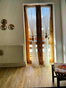 an empty room with a door with curtains on it at A casa di Giulia in Filettino