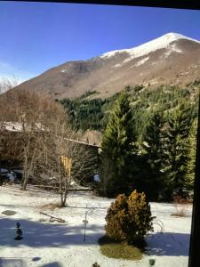 a snow covered mountain with a house and trees at A casa di Giulia in Filettino