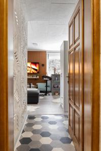 a hallway with a door and a living room at Apartman Bn Vlasic in Vlasic