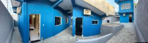 a blue building with a door and a hallway at Pousada coração da serra in Serra de São Bento +5 photos