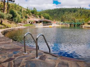 a body of water with two handles in the water at A Casa da Azenha in Sertã