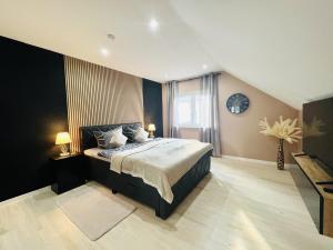 a bedroom with a large bed with two lamps at Spacious home in quiet surroundings in Schwanden