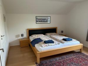 a bedroom with a bed with two pillows on it at Gemütliche Wohnung in Baldham bei München in Vaterstetten