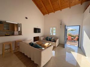 a living room with couches and a table and a kitchen at Villa Zola with Views in Zóla