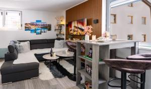 a living room with a couch and a table at Apartman Bn Vlasic in Vlasic