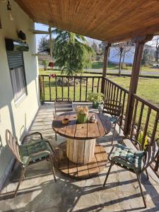 a patio with a table and chairs on a deck at Kerkini's Harmony House in Kerkini