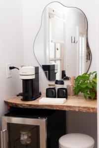 a counter with a mirror and a coffee maker on it at sisu, a boutique motel in Plymouth +54 photos