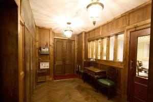 a bathroom with wooden walls and a sink and a table at The Ambassador Hotel in Inverness +128 photos