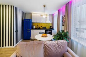 a living room with a couch and a table at Stilinga studija su visais patogumais in Šiauliai