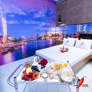 a tray of food on a table with a view of a city at Motel Você Que Sabe Temático Deluxe in Cacoal