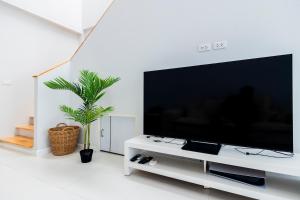 a living room with a large flat screen tv at SPACIOUS AND BRIGHT 2BR TownHouse7 MonkeyHill in Ban Sam Kong +48 photos