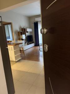 a door leading into a room with a living room at Comfortable Family Apartment P3 in Larisa