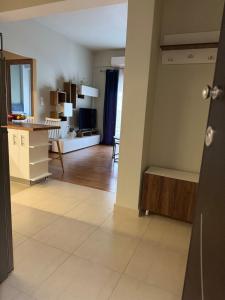 a living room with a kitchen and a dining room at Comfortable Family Apartment P3 in Larisa +2 photos