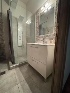 a bathroom with a shower and a sink and a mirror at Comfortable Family Apartment P3 in Larisa