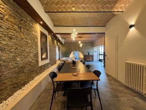 a dining room with a wooden table and chairs at Relais Portaluna delle Langhe, Private Estate with Pool, 7 Bedrooms, Sleeps 18, Vineyard Views in Mango +101 photos