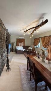 a large living room with a bed and a table at Kerkini's Harmony House in Kerkini