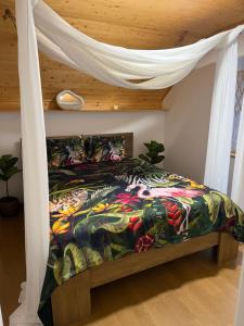 a bed with a colorful comforter in a bedroom at Vila na Vrhu in Rakovac +32 photos