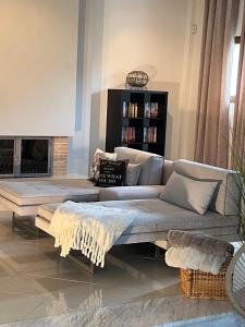 a living room with a couch and a fireplace at Loui's Garden House in Thessaloniki