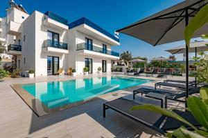 a villa with a swimming pool in front of a building at Private Villa Ksamil in Ksamil
