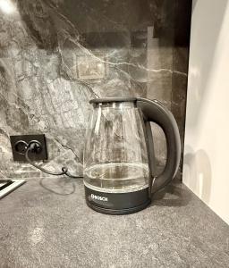 a glass jug filled with water sitting on a counter at Two-room apartment in Astana