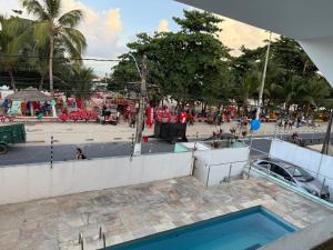 a swimming pool with a crowd of people in a park at CASAMAR Olinda in Olinda