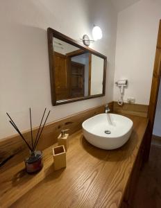 a bathroom with a white sink and a mirror at La casa di Haka in Spogna +13 photos