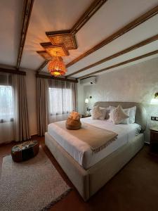 a bedroom with a large bed in a room at Riad abi khancha in Chefchaouen +32 photos