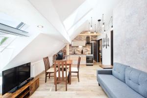a living room with a blue couch and a table at Apartmány Andrea s wellness in Zdíkov