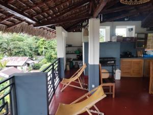 a room with two chairs on a balcony at Villa Magic in Nosy Be