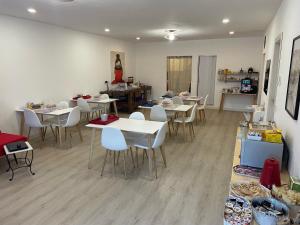 a dining room with white tables and white chairs at B&B la cruna deLago in Omegna +35 photos