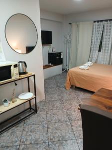 a hotel room with a bed and a mirror at Palmeras II in Vicente López