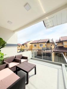 a balcony with chairs and tables and a large window at The Tuscan Townhouse in Tarlac