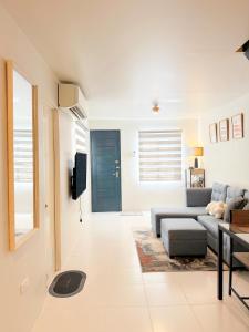 a living room with a couch and a table at The Tuscan Townhouse in Tarlac