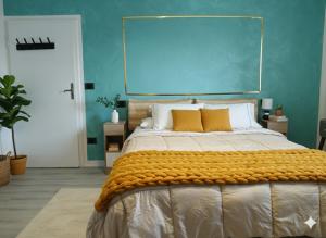 a bedroom with a large bed with a blue wall at B&b GIOIA in Massa Lombarda