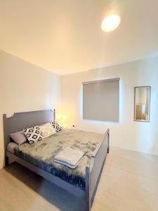 a bedroom with a bed and a large screen at The Tuscan Townhouse in Tarlac +21 photos