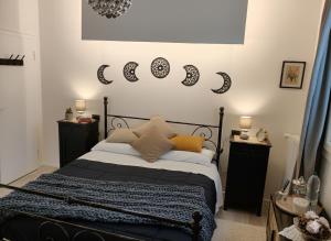 a bedroom with a bed with moon signs on the wall at B&b GIOIA in Massa Lombarda +4 photos