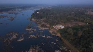an aerial view of a house next to a river at Monkey River Resort Madla in Rājgarh