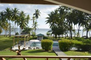 a view of a resort with a pool and palm trees at Hooked on Panama Lodge in Limones