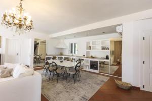 a kitchen and living room with a table and chairs at Villa Nivara in Floridia