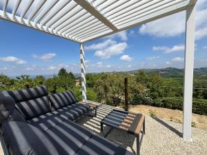 a living room with a couch and a table at Relais Portaluna delle Langhe, Private Estate with Pool, 7 Bedrooms, Sleeps 18, Vineyard Views in Mango