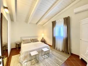 a bedroom with a bed and two tables at Villa Nivara in Floridia
