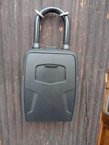 a black purse hanging on a wooden wall at Valdidentro sweet home in Valdidentro