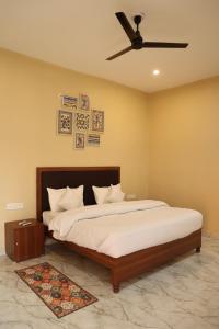 a bedroom with a large bed with a ceiling fan at Monkey River Resort Madla in Rājgarh +71 photos