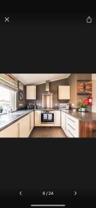 a kitchen with white cabinets and a stove top oven at Lazy Days Lodge in Malton