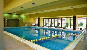 a large swimming pool in a large building at Apartment Danik City Garden in Bansko +20 photos
