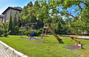 a playground with a slide in a yard at Apartment Danik City Garden in Bansko